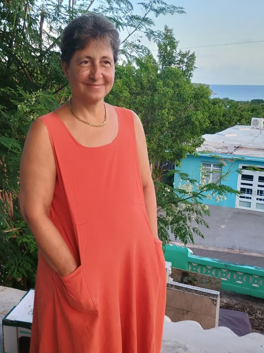 Michelle in an orange dress, offering encouragement